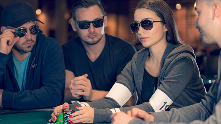 Female Poker Player Grabbing Piles of Poker Chips