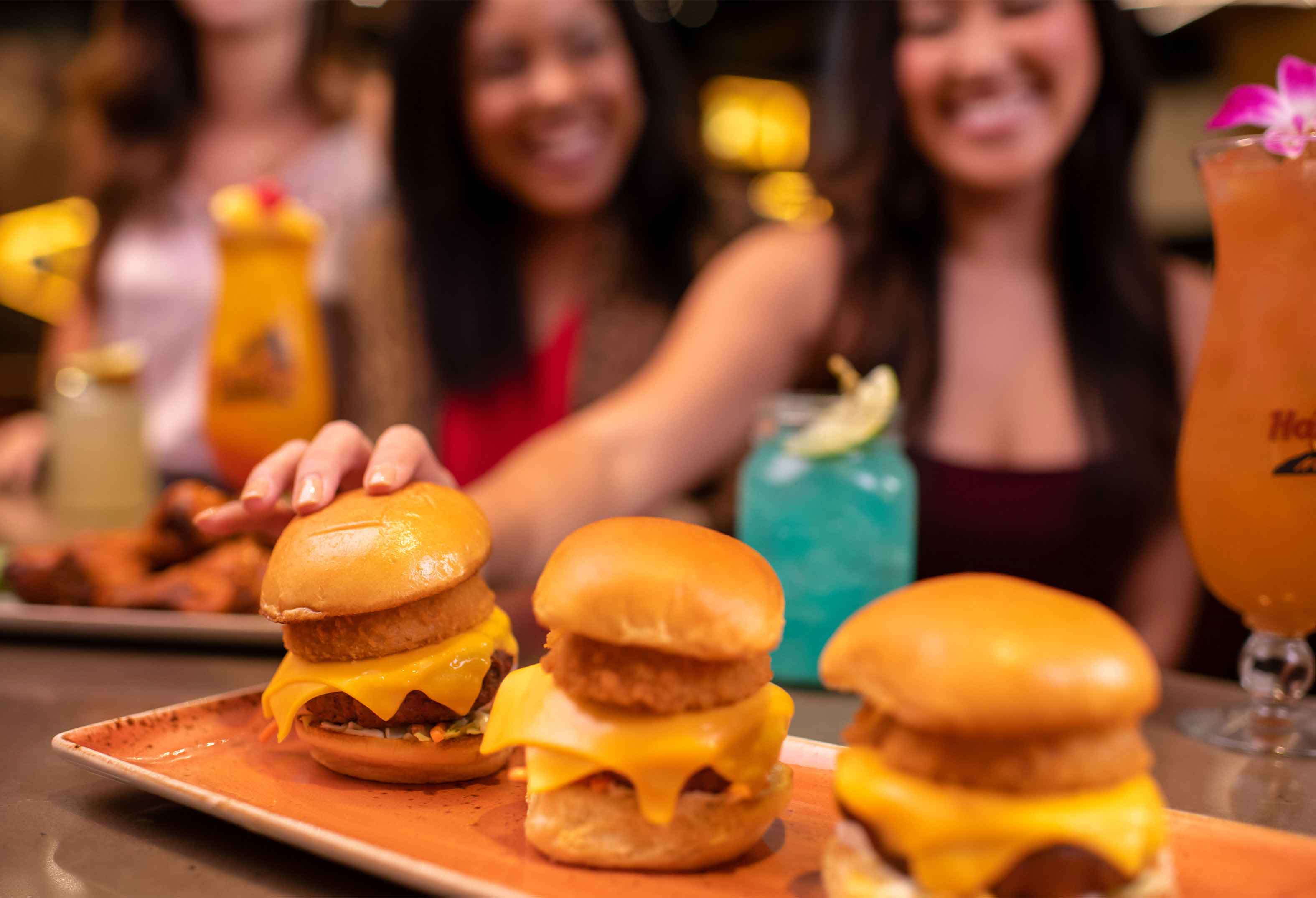 Group of Women Enjoying Burgers and Cocktails at Hard Rock Cafe